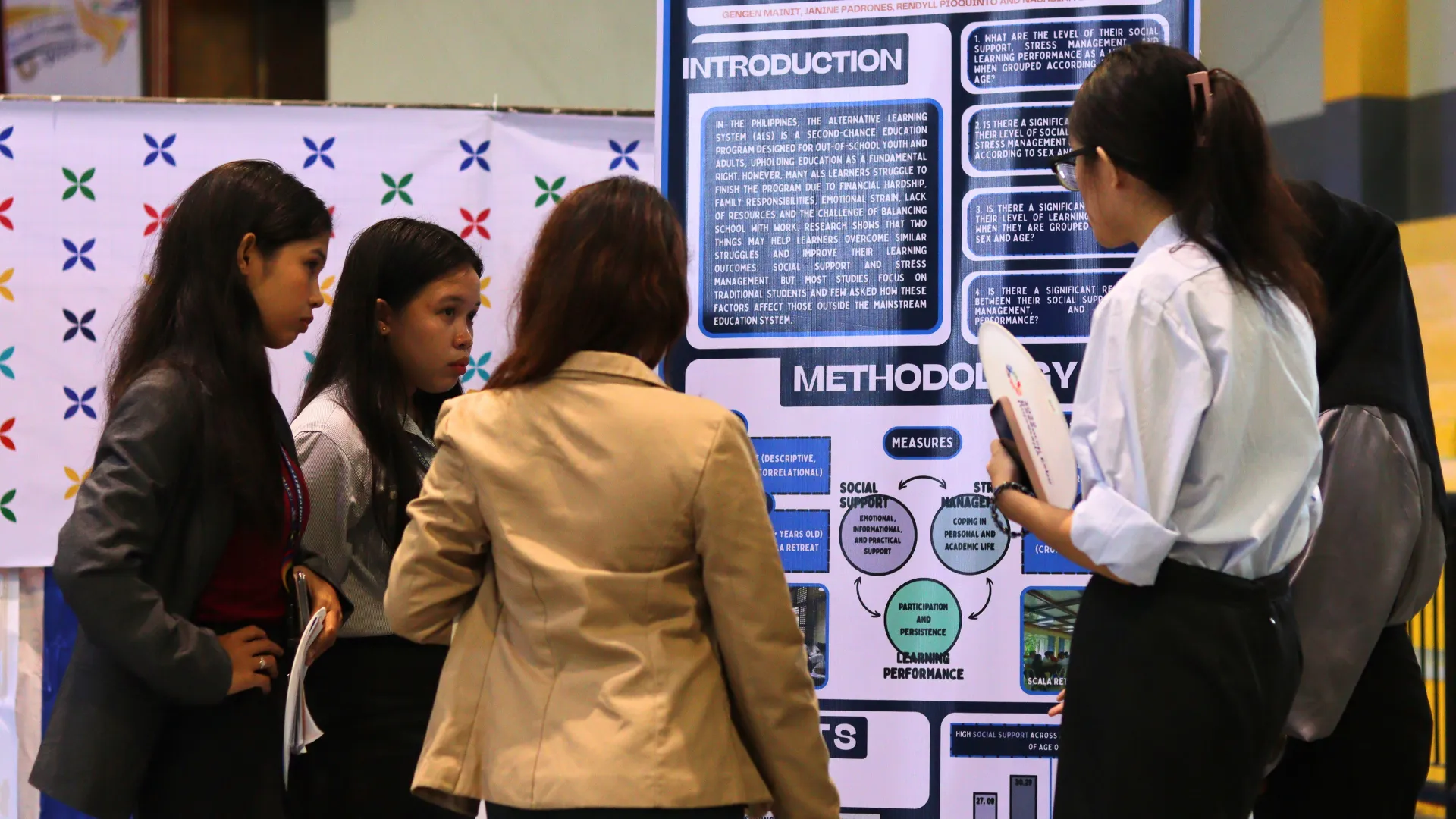 Students discussing a research poster at a university research presentation